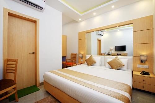 a hotel room with a bed and a mirror at De Lagom Comforts, Anjuna Beach - A boutique hotel in Anjuna