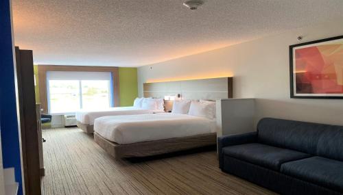 a hotel room with two beds and a couch at Holiday Inn Express Hotel & Suites Somerset Central by IHG in Somerset