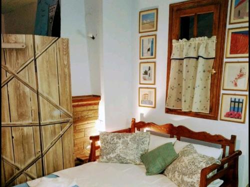 a bedroom with a bed and a wooden door at Studio Sunday morning Μούρεσι Πηλίου in Mouresi