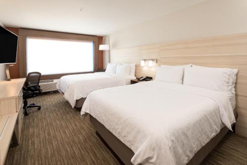 a hotel room with two beds and a television at Holiday Inn Express & Suites - Portage, an IHG Hotel in Portage