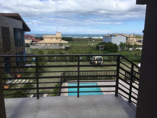 a balcony with a view of a pool at Garopaba - Praia da Gamboa - Apartamento com piscina in Garopaba