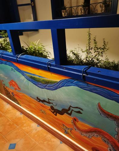 a table with a painting of a dragon on it at Tigmi Blue - Imsouane Surf et Océan in Imsouane
