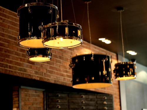a group of drums hanging from a ceiling at Hotel Indigo Liverpool by IHG in Liverpool