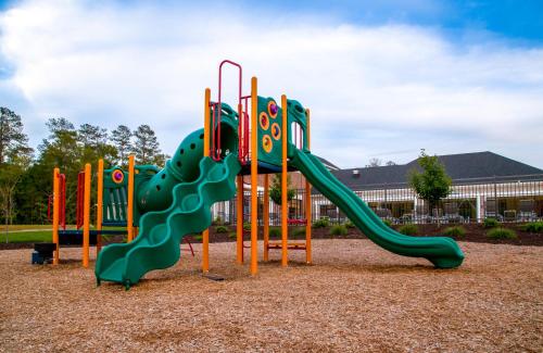 a playground with a slide in front of a building at Holiday Inn Club Vacations Williamsburg Resort in Williamsburg