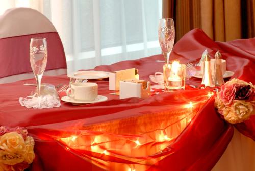 a table with a red table cloth with lights on it at Holiday Inn & Suites North Vancouver by IHG in North Vancouver