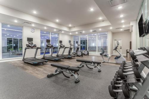 a gym with several treadmills and machines in a room at Holiday Inn & Suites - Jefferson City by IHG in Jefferson City