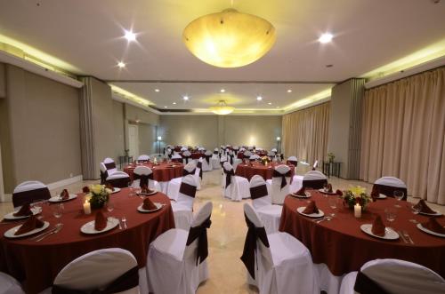 a banquet hall with tables and chairs in a room at Holiday Inn Hotel & Suites Centro Historico by IHG in Guadalajara