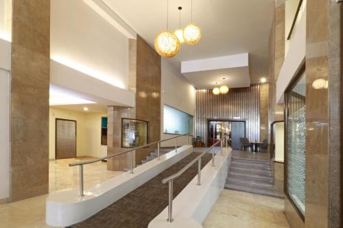 a lobby of a building with a staircase at Holiday Inn Hotel & Suites Centro Historico by IHG in Guadalajara