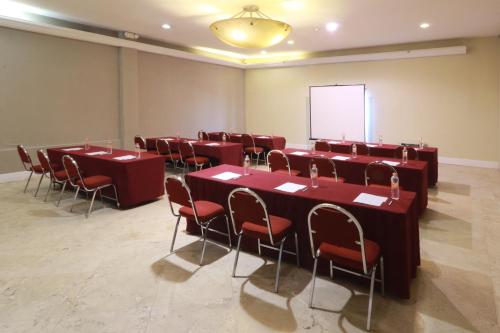 a conference room with tables and chairs and a whiteboard at Holiday Inn Hotel & Suites Centro Historico by IHG in Guadalajara