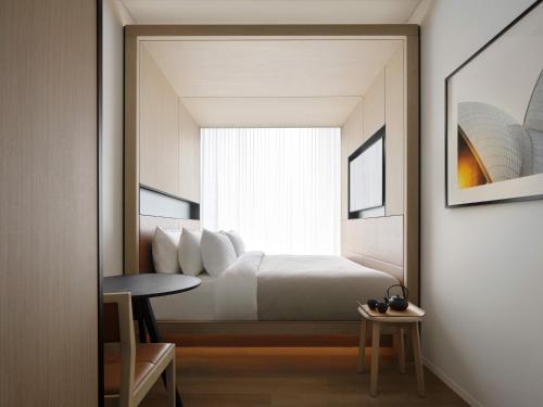 a bedroom with a bed and a window at Little National Hotel Sydney in Sydney