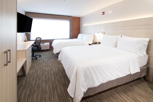 a hotel room with two beds and a television at Holiday Inn Express & Suites La Porte by IHG in LaPorte