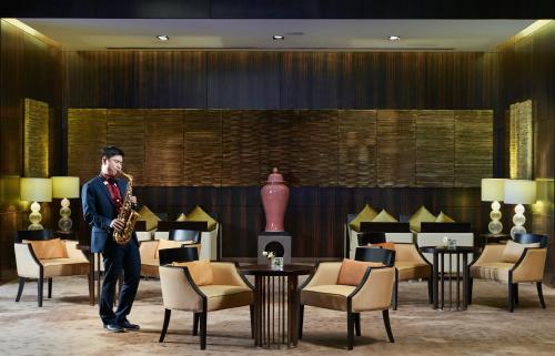 a man playing a saxophone in a hotel lobby at The Azure Ningbo, Vignette Collection in Ningbo