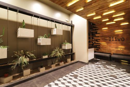 a lobby with potted plants on the wall at Holiday Inn Hotel & Suites Hermosillo Aeropuerto by IHG in Hermosillo