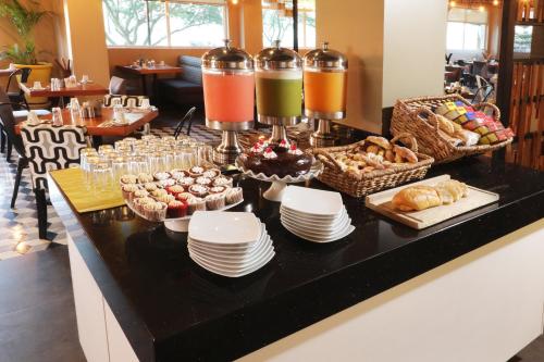 a buffet with plates and pastries on a table at Holiday Inn Hotel & Suites Hermosillo Aeropuerto by IHG in Hermosillo