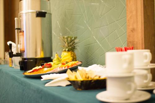 a blue table with two plates of food on it at Holiday Inn Hotel & Suites Hermosillo Aeropuerto by IHG in Hermosillo