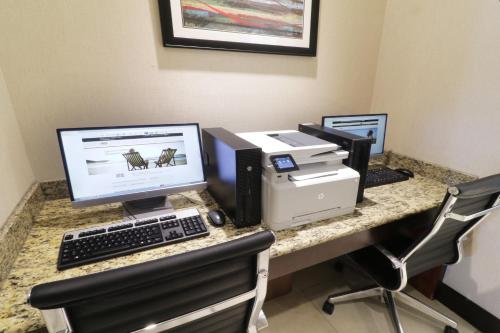 a desk with a computer and a printer on it at Holiday Inn Hotel & Suites Hermosillo Aeropuerto by IHG in Hermosillo