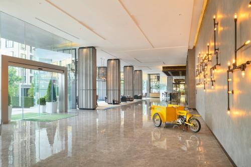 a yellow motor bike parked in a lobby at Holiday Inn & Suites Siracha Laemchabang by IHG in Si Racha