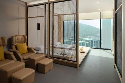 a living room with a view of a balcony at Holiday Inn & Suites Siracha Laemchabang by IHG in Si Racha