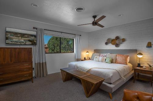 ein Schlafzimmer mit einem Bett, einer Kommode und einem Fenster in der Unterkunft Bell Rock Drive Sedona in Sedona