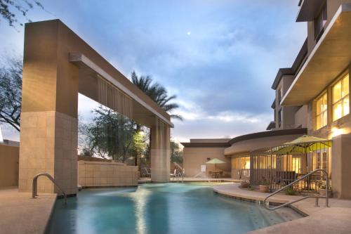 a swimming pool in front of a building at Holiday Inn Scottsdale North- Airpark by IHG in Scottsdale
