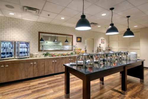 a large kitchen with a table in the middle at Holiday Inn & Suites Atlanta Airport North by IHG in Atlanta