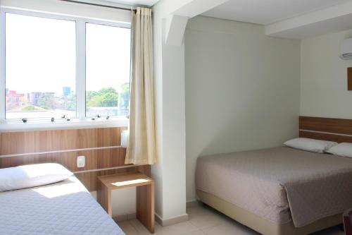 Postel nebo postele na pokoji v ubytování Tri Hotel Smart Chapecó