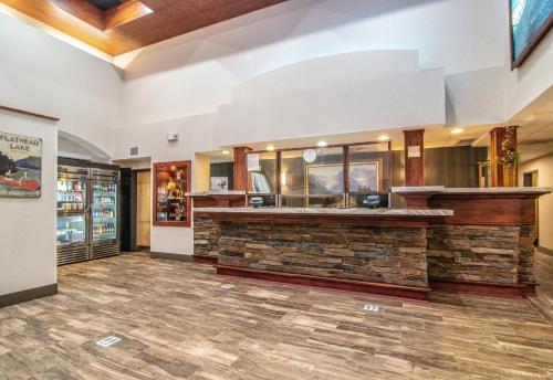 a lobby of a restaurant with a stone counter at Holiday Inn Express Hotel & Suites Kalispell by IHG in Kalispell