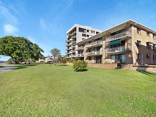 
a large building with a large lawn in front of it at 5/18 Endeavour Parade - Riverfront Tweed Heads in Tweed Heads
