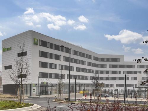 a large white building with a lot of windows at ibis Styles Paris Orly Airport in Paray-Vieille-Poste