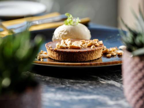 a chocolate pie with a ice cream on a plate at Mercure Luxembourg Kikuoka Golf & Spa in Canach