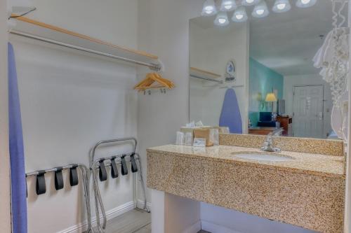 a bathroom with a sink and a mirror at Rio Del Sol Inn Needles in Needles