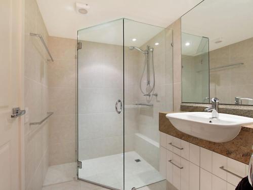 bagno con doccia in vetro e lavandino di Carool Unit 25 a Gold Coast