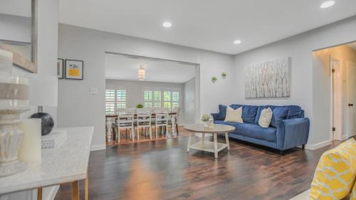 a living room with a blue couch and a table at Heart of NPB in North Palm Beach