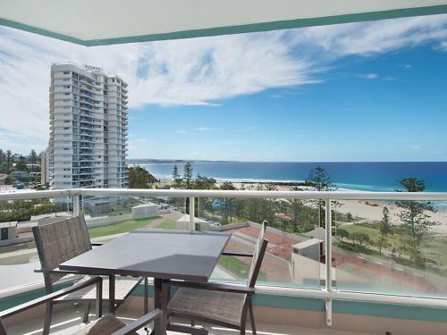 a balcony with a table and chairs and a view of the ocean at Ocean Plaza Unit 936 in Gold Coast