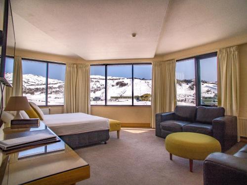 a hotel room with a bed and a couch at Marritz Hotel in Perisher Valley