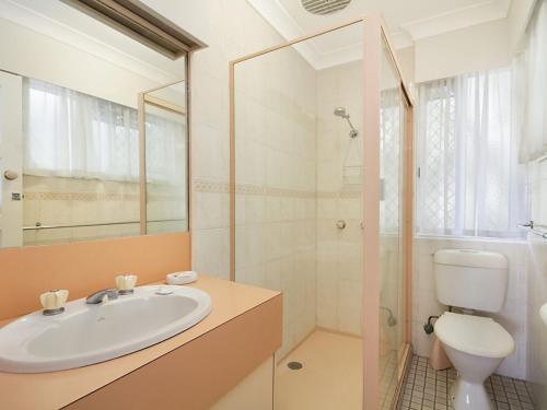 a bathroom with a sink and a toilet and a shower at Tondio Terrace Flat 2 in Gold Coast