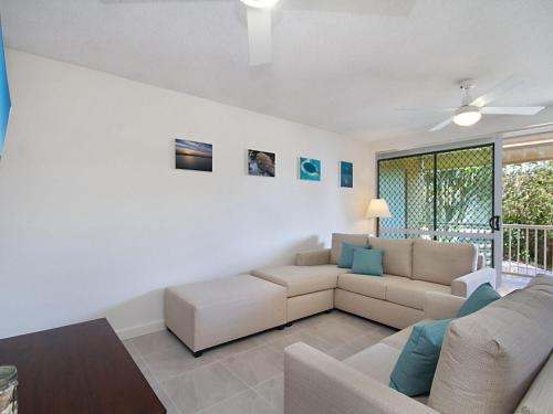 
a living room filled with furniture and a window at Woobera Unit 14 - On the hill overlooking Tweed Heads and Coolangatta in Tweed Heads

