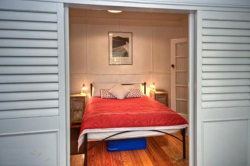 a bedroom with a bed with a red comforter at Finchley in Blackheath