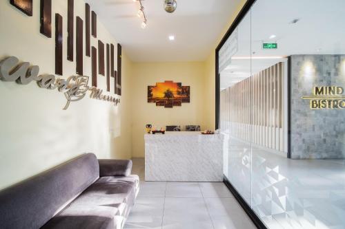 a lobby with a couch and a bar at Arden Hotel and Residence by At Mind in Pattaya Central