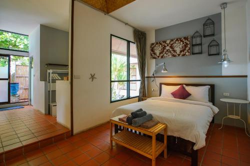 a bedroom with a bed and a table with a teddy bear on it at Koh Munnork Private Island in Ko Munnork