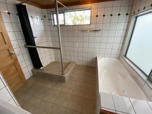a bathroom with a shower and a tub at Aorangi House in Lake Tekapo