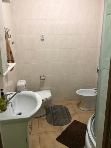 a bathroom with a sink and a toilet at Hotel - Hostel Marichka in Khmilnyk