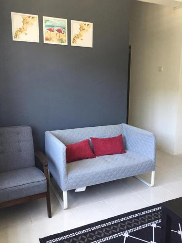 a living room with a blue couch and a chair at Cinnamon Sutravilla Unit No D3A6 Lift Level 4, Sutravilla 2 in Kuantan
