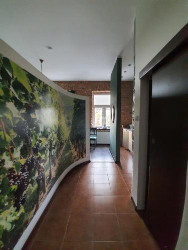 a hallway with a large painting on the wall at Nowy Rynek 10 in Płock