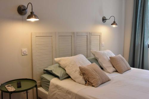 a bedroom with a bed with pillows on it at Domaine de Sévanes in Saint-Paul-les-Fonts