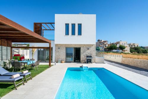 a swimming pool in the backyard of a house at Lux Villa Nymphes Dioni, 30m from beach with Pool, BBQ and Play Area in Stavromenos