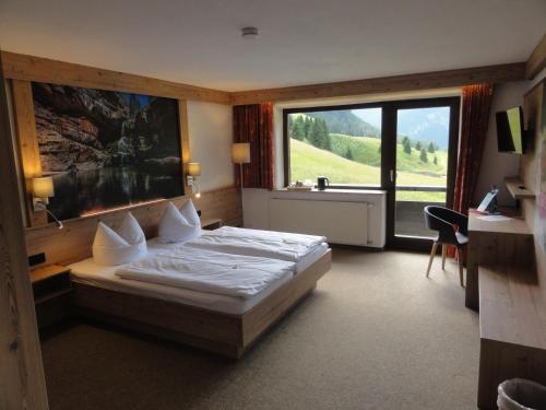 a bedroom with a bed and a large window at Quartier Severin in Berwang
