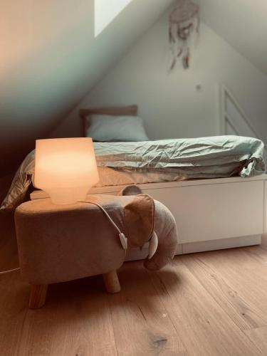 a bedroom with a bed with a lamp on it at Lichtrijke loft bij restaurant Den Olifant in Ypres