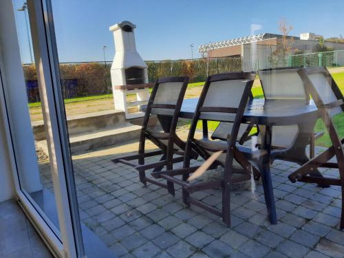 a table and chairs sitting on a patio with a fireplace at Lacs de l'eau d'heure VINEUF in Erpion