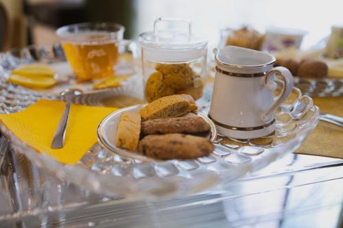 a glass tray with a plate of food on a table at La Maison Di Carla in Ancona